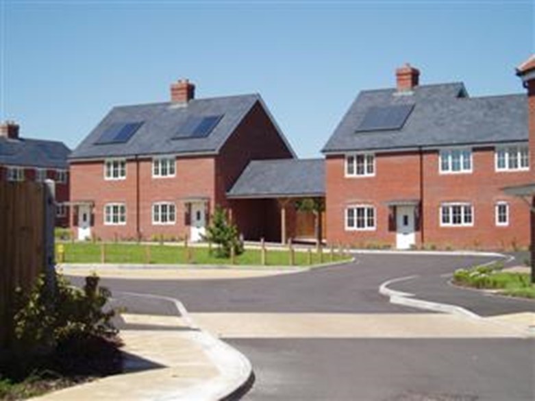 Some of the homes built by Wickham CLT and Hyde Housing Group: a selection of red brick houses with grey rooves